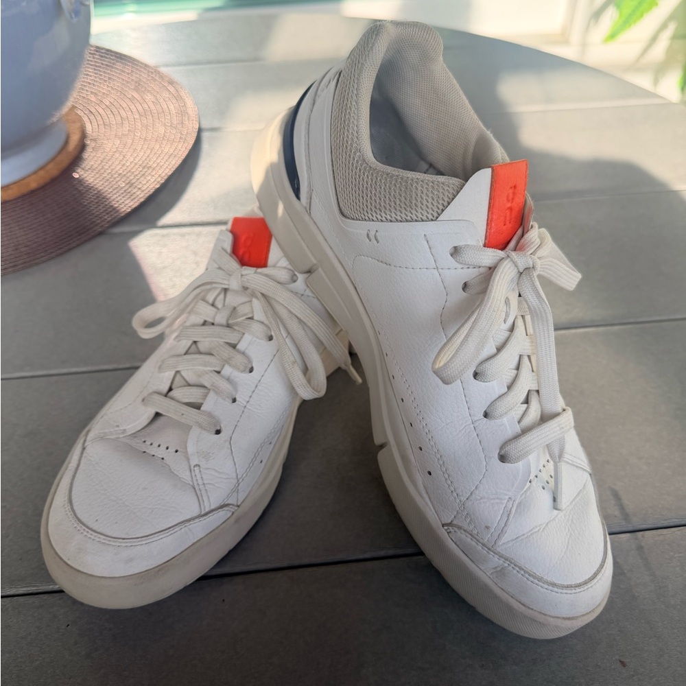 On Running White and Orange Sneakers